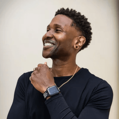 Ervin Coty smiling, wearing a black shirt